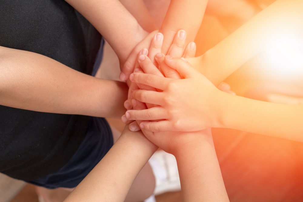 Partnerships 1 hands all in together